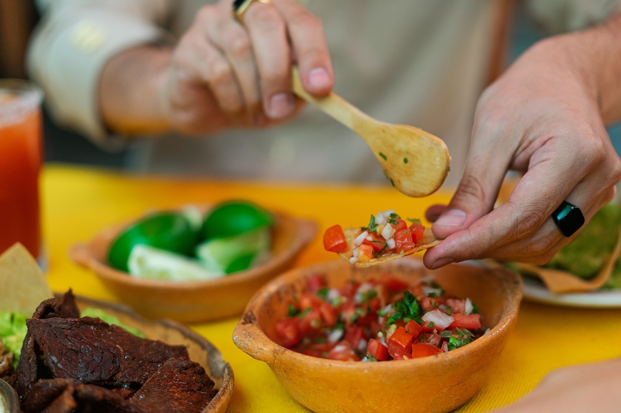 Instant Pot Cinco de Mayo Recipes Close Up of a Person Dipping Chips in Salsa
