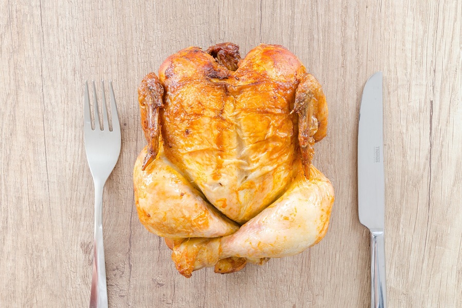 Chicken and Gravy Crockpot Recipes a Whole Roasted Chicken on a Wooden Surface