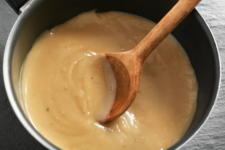 Chicken and Gravy Crockpot Recipes a Pot of Gravy with a Wooden Spoon Inside