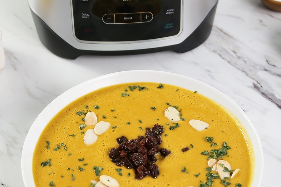 Instant Pot Ace Blender Tips and Tricks Bowl of Soup in Front of an Ace Blender on a Marble Surface