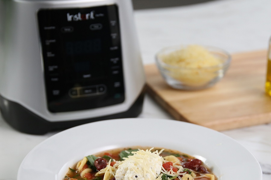 Instant Pot Ace Blender Tips and Tricks Hearty Bowl of Soup with Noodles and Cheese in Front of an Ace Blender