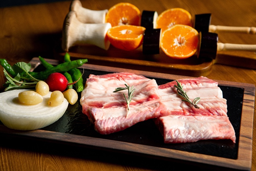 Slow Cooker Short Ribs Recipes Uncooked Short Ribs on a Cutting Board with Herbs and Oranges Cut in Half