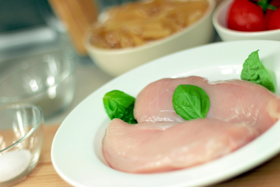 Best Slow Cooker Recipes with Chicken Close Up of a Plate of Raw Chicken Breasts