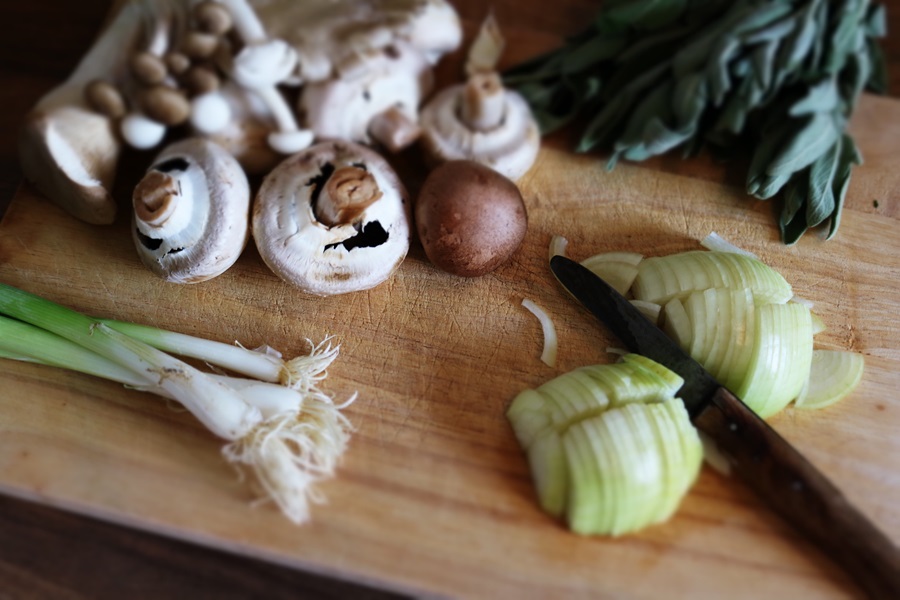 Healthy Crockpot Snack Recipes Mushrooms, Green Onions, and Onions on a Cutting Board