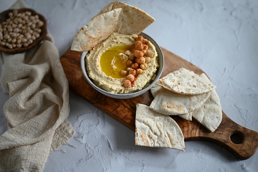 Healthy Crockpot Snack Recipes Humus with Pita Bread on a Serving Tray