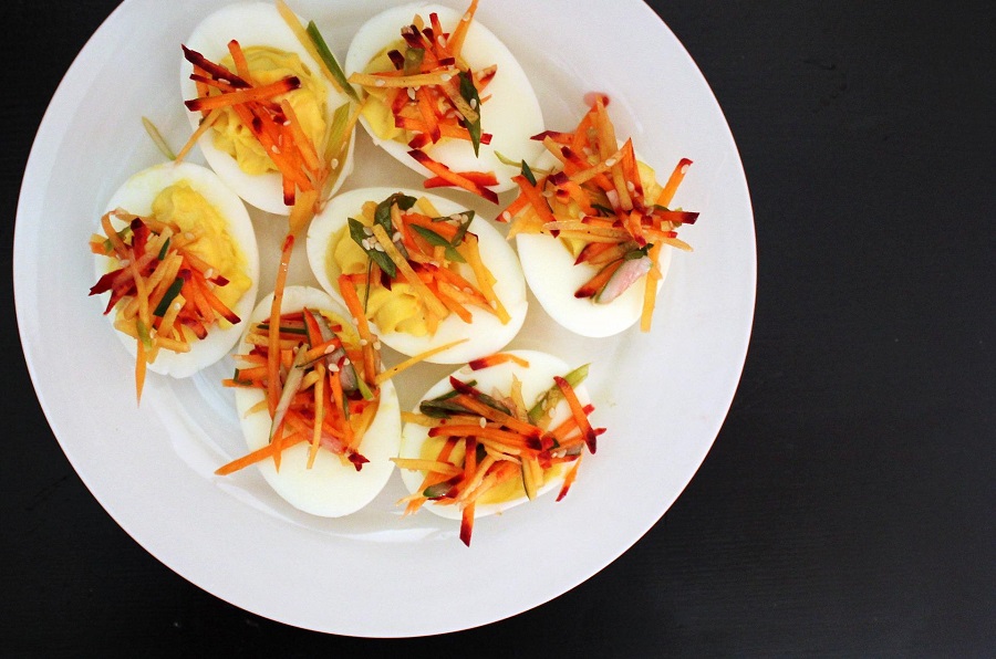 How to Make Instant Pot Hard Boiled Eggs Overhead of a Platter of Hard Boiled Eggs Topped with Veggies