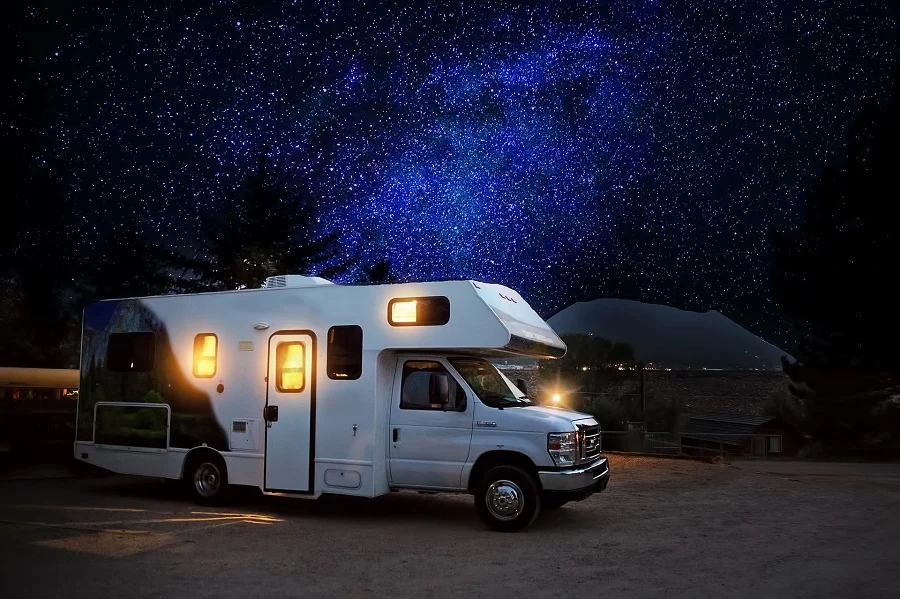 Crockpot Recipes for Camping RV Parked Under the Stars with a Small Hill in the Background
