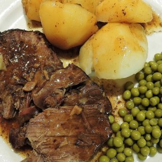 How to Make Instant Pot Beef Roast Overhead View of a Plate with Roast Beef, Potatoes, and Peas