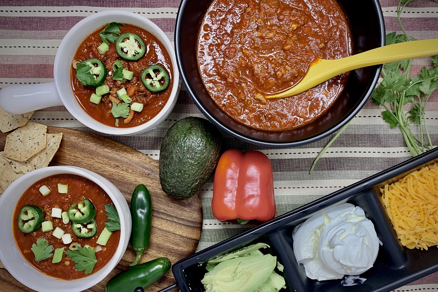How to Make Instant Pot Chili Overhead View of a Bowl of Chili with Two Smaller Bowls of Chili Next to it