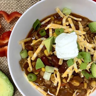 How to Make Instant Pot Chili Overhead View of a Bowl of Chili with Turkey, Cheese, Avocado, and Sour Cream