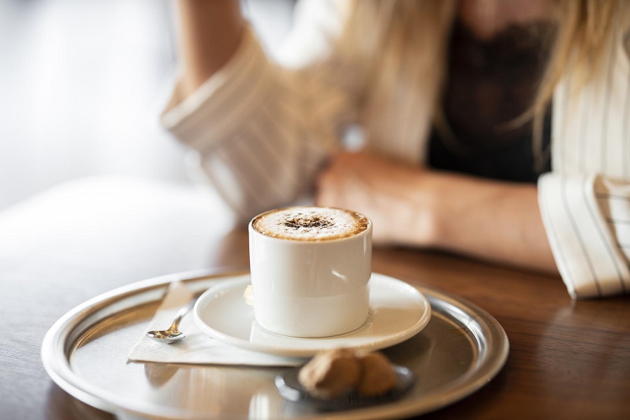 Slow Cooker Breakfast Recipes Close Up of a Woman Sitting at a Table Drinking Coffee