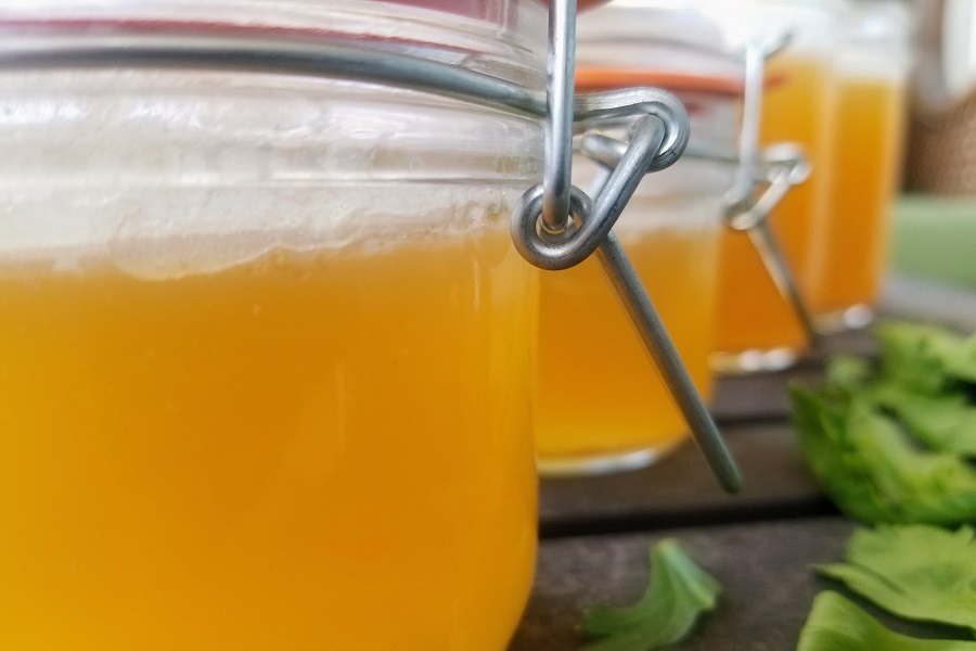 How to Make Instant Pot Chicken Broth Close Up of a Glass Jar Filled with Broth