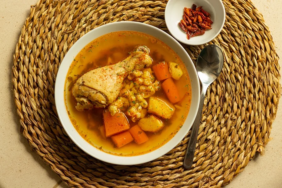 How to Make Instant Pot Chicken Broth a Bowl of Broth with a Drumstick Inside as well as Carrots, and Other Veggies