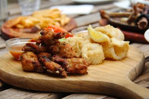 Instant Pot Chicken Wings Close Up of Wings with Calamari on a Wooden Serving Tray