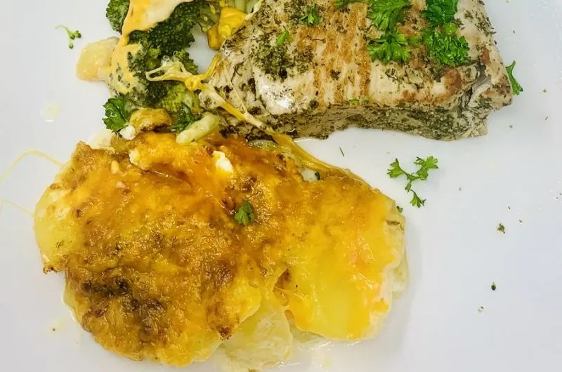 Fall Instant Pot Dinner Recipes Close Up of a Serving of Scalloped Potatoes with Pork Chops on a Plate