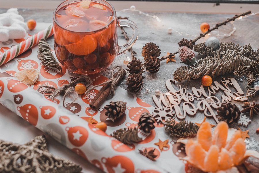 Crockpot Sangria Recipes a Glass of Sangria on a Roll of Wrapping Paper with Pinecones and Holiday Decor Scattered Around