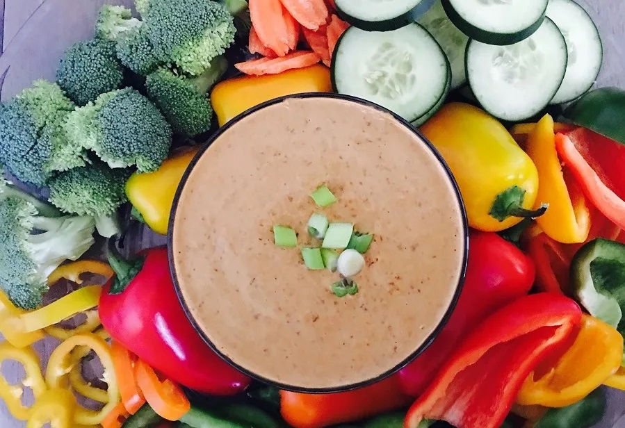 Crockpot Holiday Appetizers Overhead View of a Bowl of Bean Dip Surrounded by Veggies