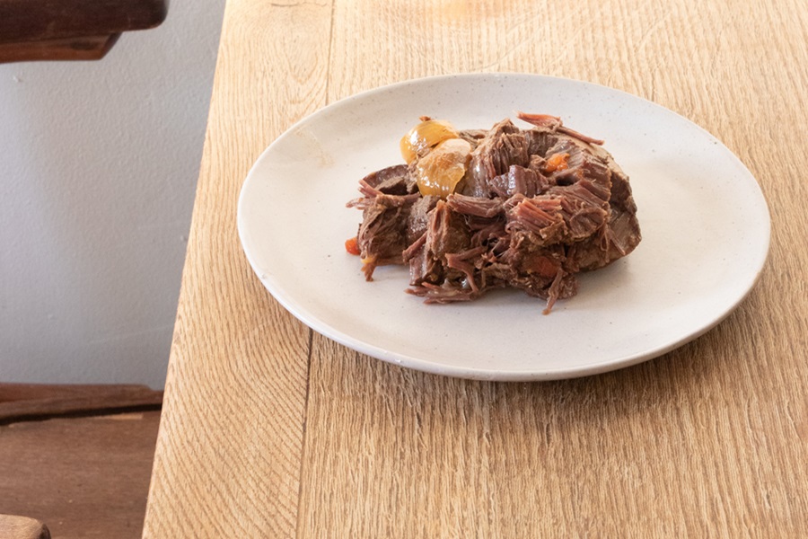 Instant Pot Chuck Roast Recipes a Plate of Shredded Beef on a Wooden Table