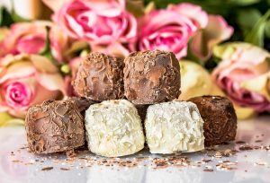 Crockpot Candy Recipes with Almond Bark Small Chocolates on a Counter with Some Roses