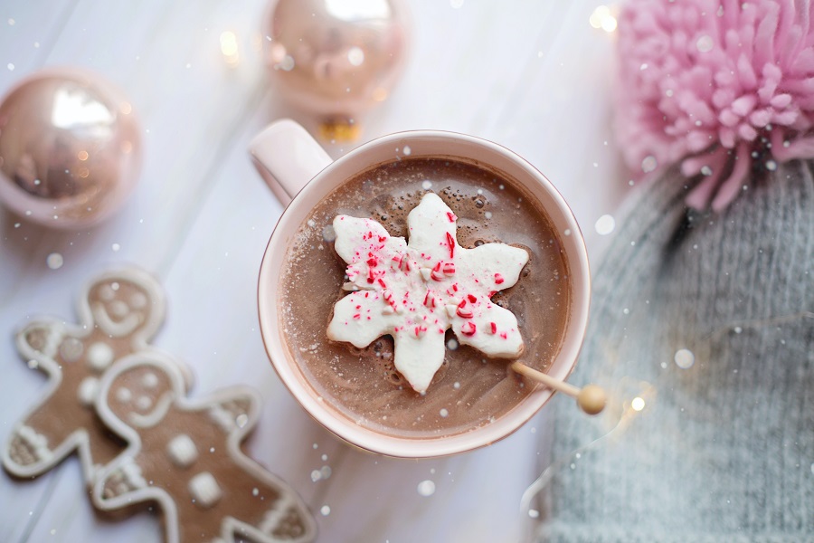 Crockpot Candy Recipes Overhead View of a Cup of Hot Chocolate with a White Chocolate and Peppermint Candy Floating On Top