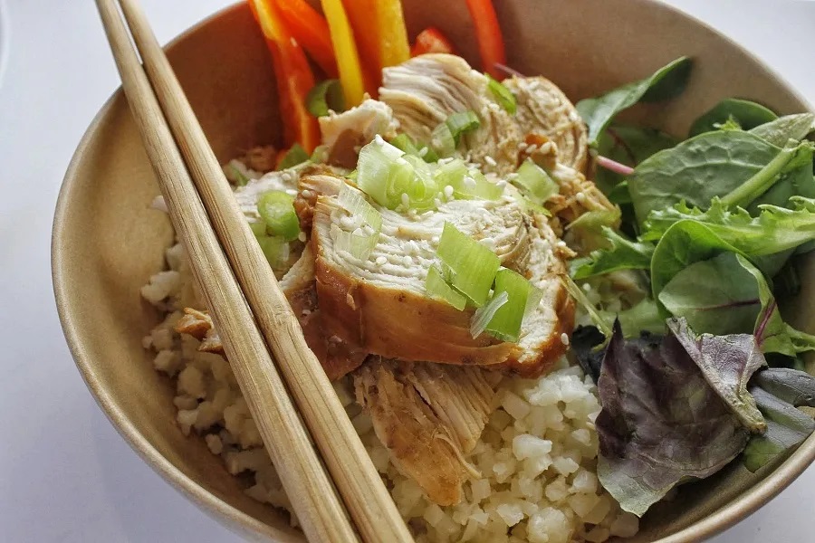 Healthy Instant Pot Family Dinners Teriyaki Chicken on some Quinoa and a Salad in a Bowl with Chopsticks