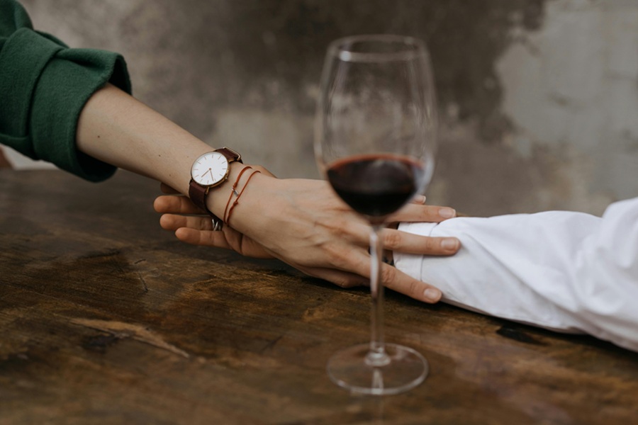 Date Night Crockpot Recipes a Couple Holding Hands on a Table with a Glass of Wine on a The Table