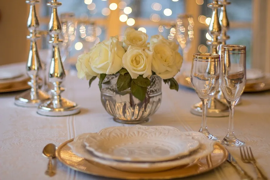 Romantic Instant Pot Recipes for Two Close Up of a White Table Setting with a Centerpiece of Roses