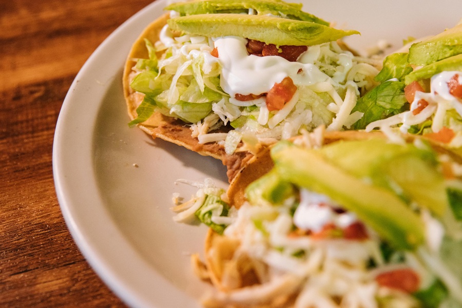 Instant Pot Frozen Chicken Recipes Close Up of a Plate of Tacos Topped with Lettuce and Avocado Slices