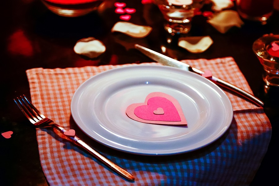 Romantic Crockpot Meals for Valentines Day a White Plate with a Pink Paper Rose on a Table