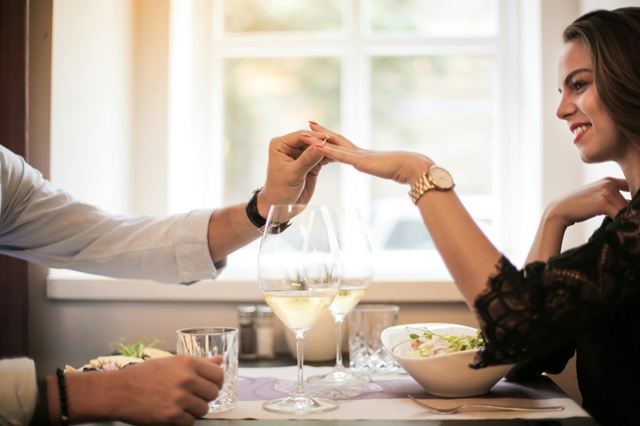Romantic Instant Pot Recipes for Two Two People Sitting at a Table with One Person's Hand Being Held by the Other