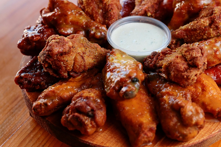 Super Bowl Appetizers Close Up of a Platter of Wings with a Small Ramekin of Ranch in the Center