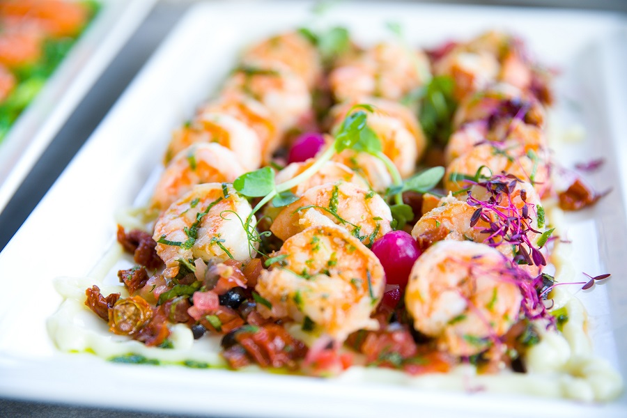 Can you Put Frozen Shrimp in Slow Cooker Close Up of a Platter with Shrimp Lined Up in Three Rows