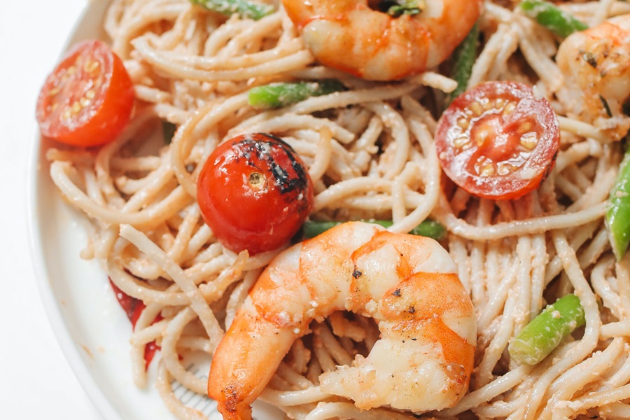 Can you Put Frozen Shrimp in Slow Cooker Close Up of a Plate of Shrimp and Pasta with Baby Roma Tomatoes