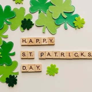 Green St Patrick's Day Crock Pot Recipes Letter Tiles Spelling Happy St Patrick's Day with Green Shamrocks Scattered Around