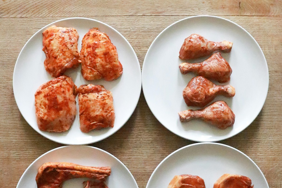 Easy Instant Pot Chicken Thighs Recipes Different Cuts of Chicken Including Thighs and Legs on Separate White Plates