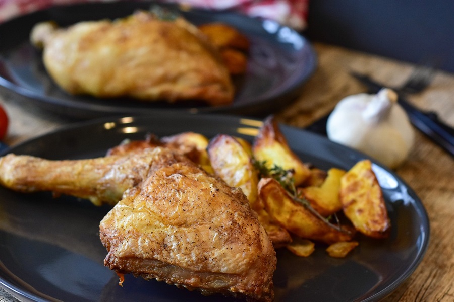 Easy Instant Pot Chicken Thighs Recipes a Chicken Thigh on a Black Plate with Roasted Potatoes