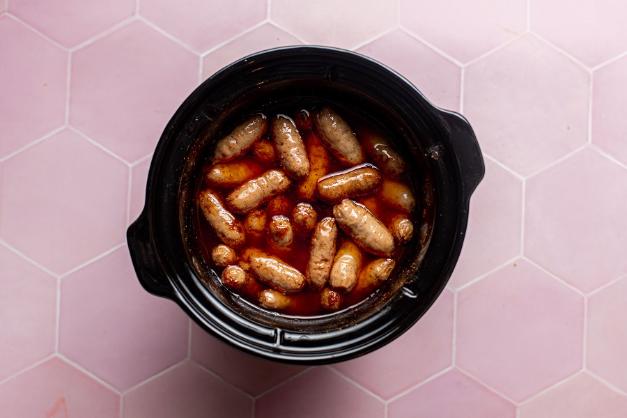 Crockpot Little Smokies with Grape Jelly and BBQ Sauce Overhead View of Little Smokies in a Crockpot with Sauce