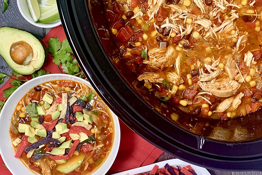 Crockpot Chicken Breast Recipes for Dinner Overhead View of a Crockpot Filled with Chicken Taco Soup with a Bowl of Soup Next to it