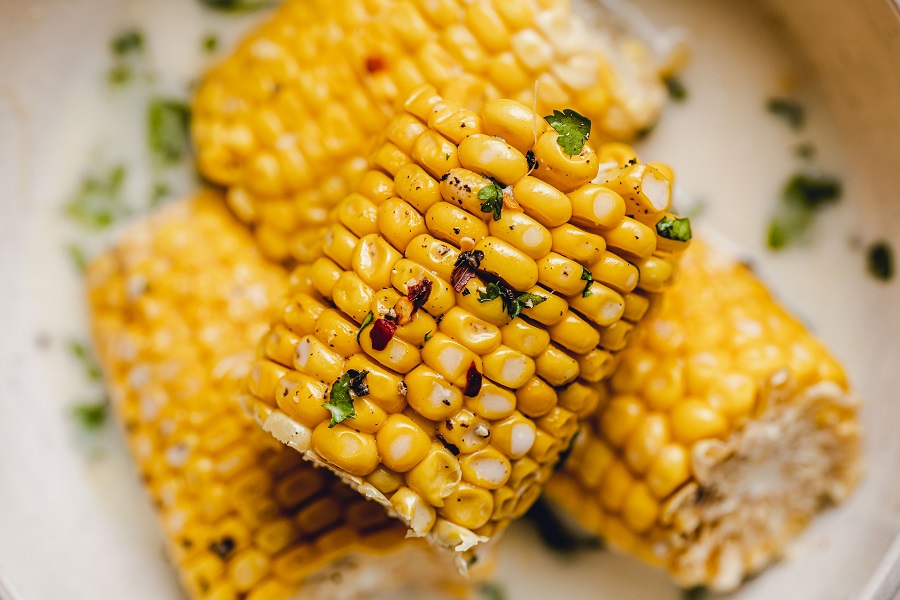 Crockpot Corn on the Cob with Coconut Milk Recipe Overhead View of Cooked Cobs Garnished with Cilantro