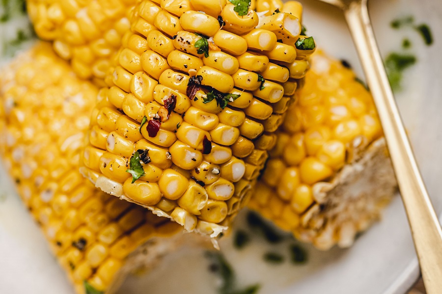 Crockpot Corn on the Cob with Coconut Milk Recipe Close Up of Cooked Cobs Garnished with Cilantro