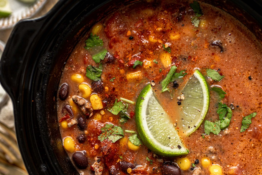 Crockpot Jokes for Laughing While You Cook Overhead View of a Crockpot Filled with Taco Soup