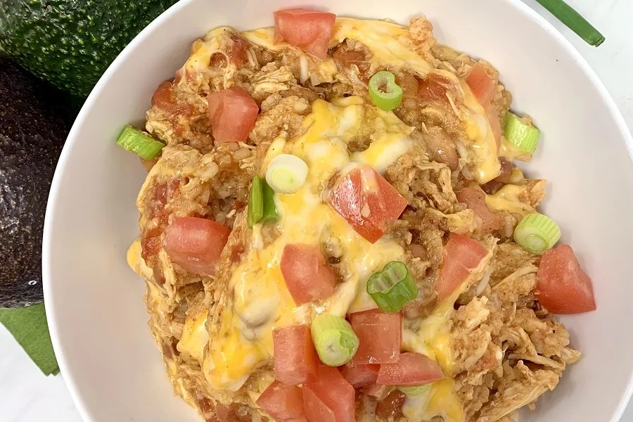 High Protein Grocery List  Overhead View of a Chicken Burrito Bowl Topped with Cheese and Diced Tomatoes