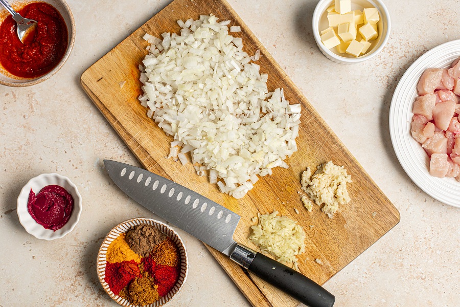 Crockpot Chicken Tikka Masala Recipe Overhead View of Minced Onion, Garlic, and Ginger on a Cutting Board