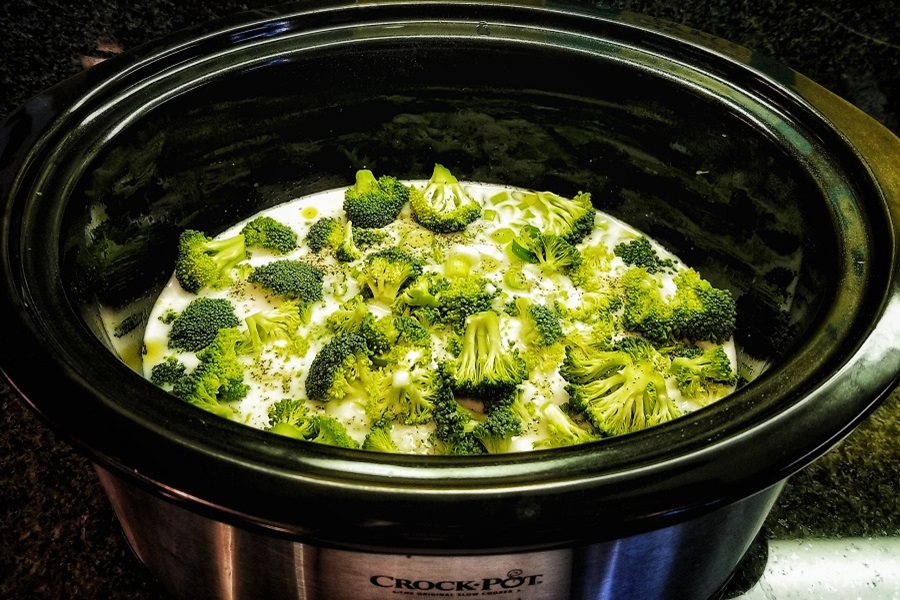 Funny Slow Cooker Quotes About the Joys of Cooking Close Up of an Open Crockpot with Broccoli Inside