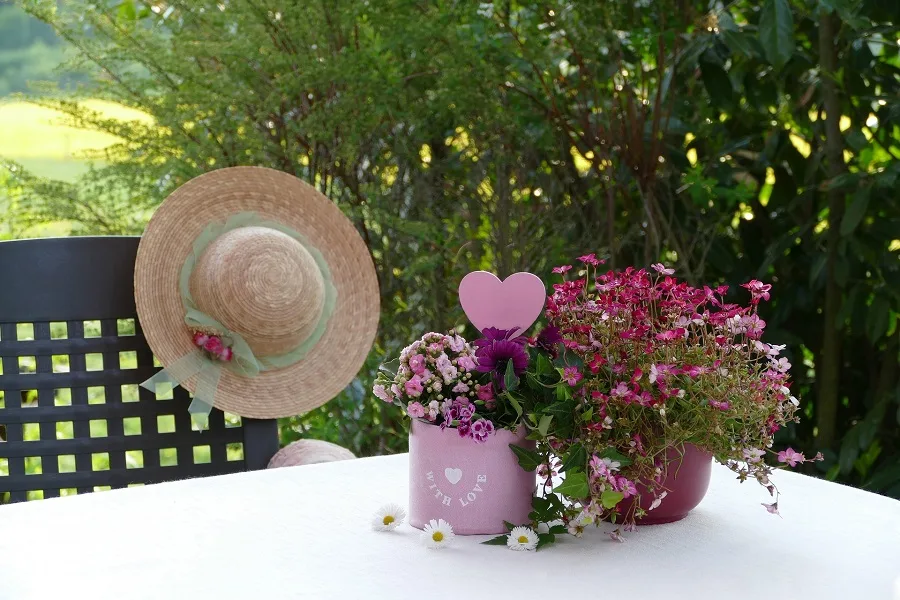 Instant Pot Spring Dinner Ideas Close Up of a Table Outside with a Chair and a Gardening Hat