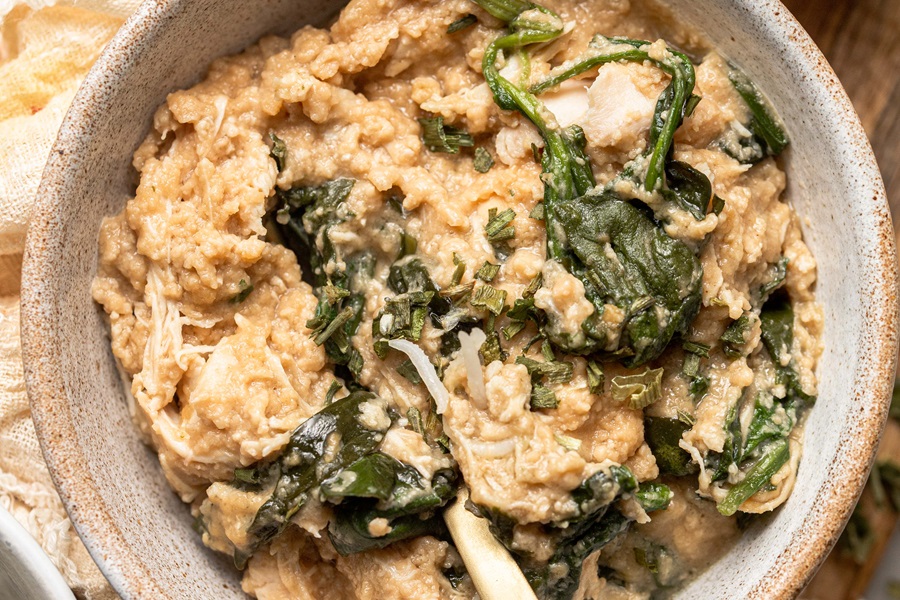 Slow Cooker Chicken and Spinach Rice Bowl Recipe Close Up of a Bowl of Chicken and Spinach with Rice Underneath