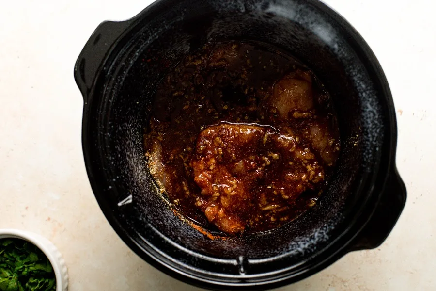 Slow Cooker Chicken Teriyaki Freezer Meal Recipe Overhead View of a Slow Cooker with Chicken and Sauce Inside