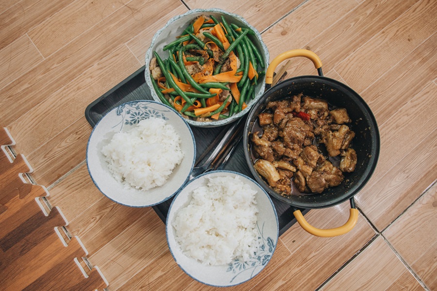 Instant Pot Rice Recipes from Around the World Overhead View of Two Small Bowls of White Rice Next to a Bowl of Veggies and Another Bowl of Meat