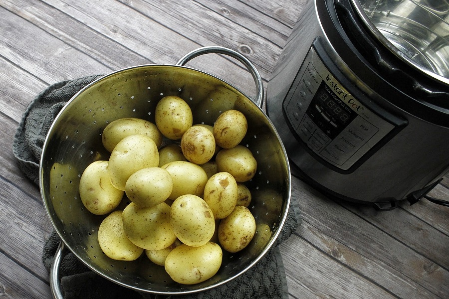 Instant Pot Quotes Overhead View of a Bowl of Potatoes Next to an Instant Pot