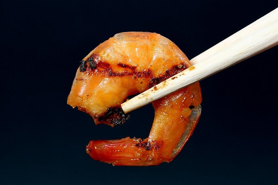 Shrimp Instant Pot Recipes Close Up of a Single Shrimp Being Held by Chopsticks